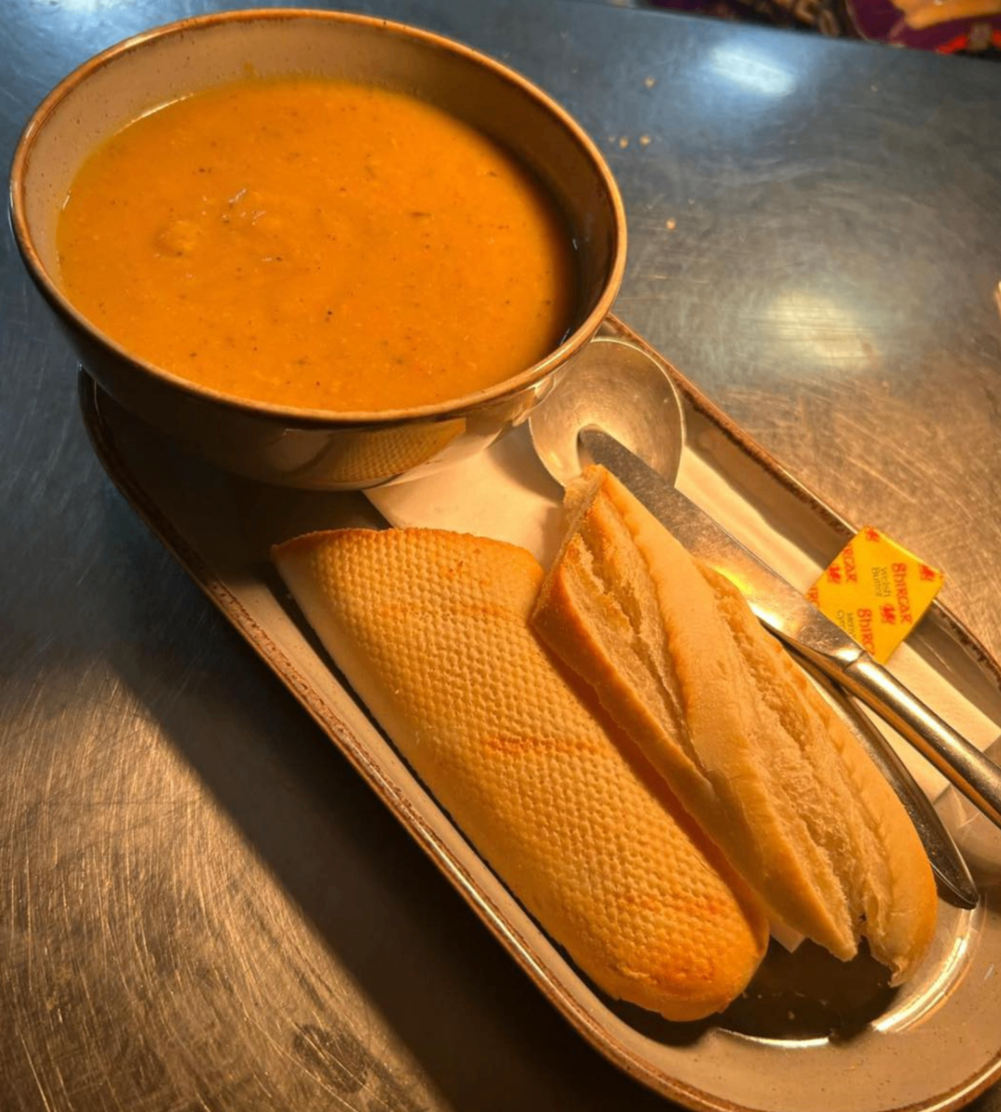 Soup served with a fresh bread roll