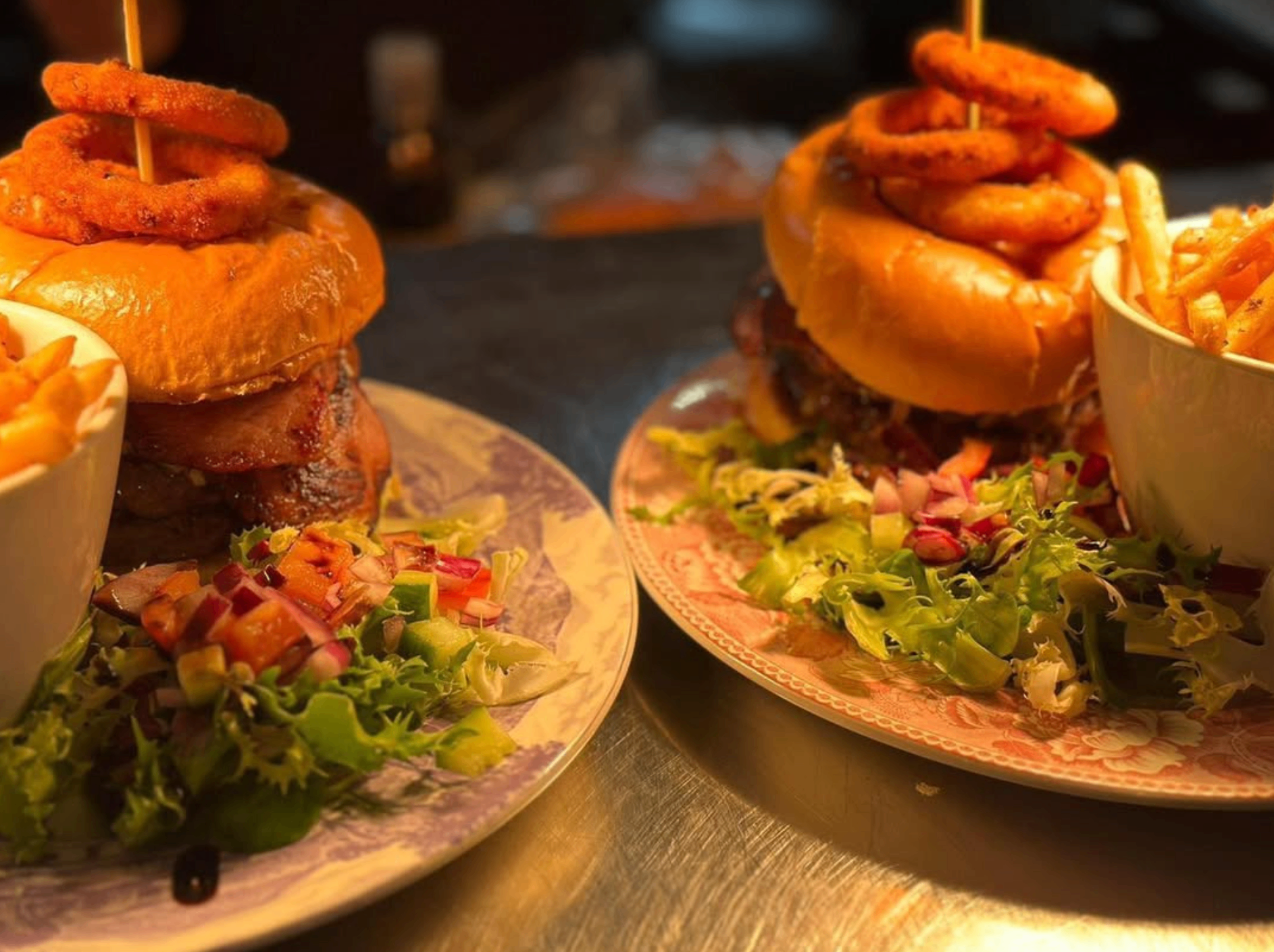Two lighthouse burgers served with salad and fries