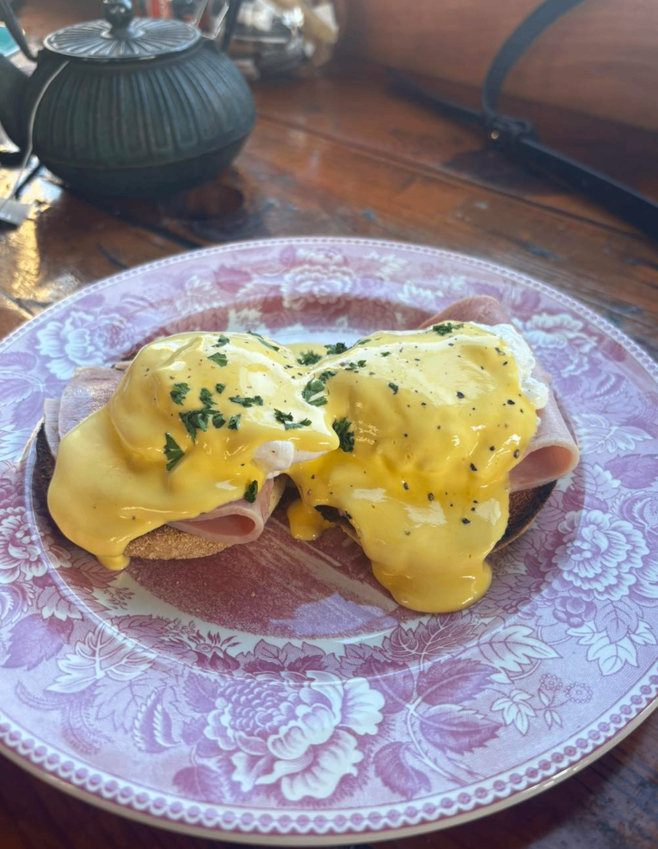Eggs benedict served on a patterned plate inside 4 Seasons Coffee House